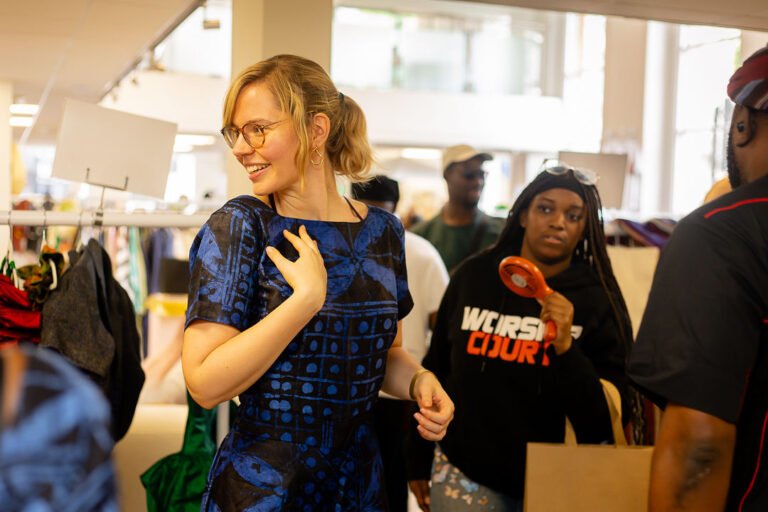 A guest in a blue printed dress